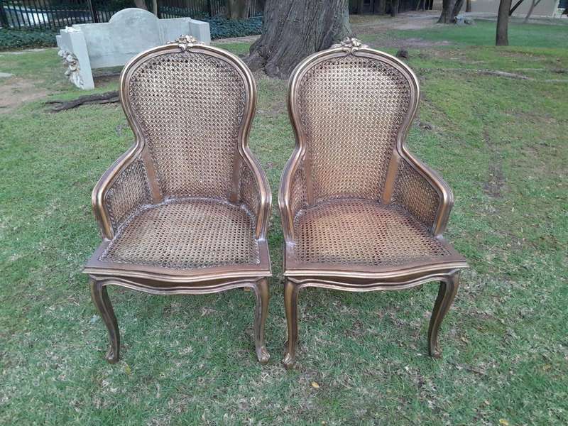 A Pair of French Style Ornately Carved and Gilded Rattan High Back Armchairs