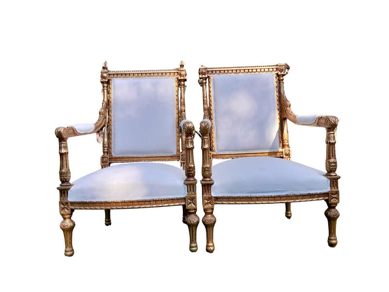 A Pair of French Style Ornately Carved Giltwood Arm Chairs