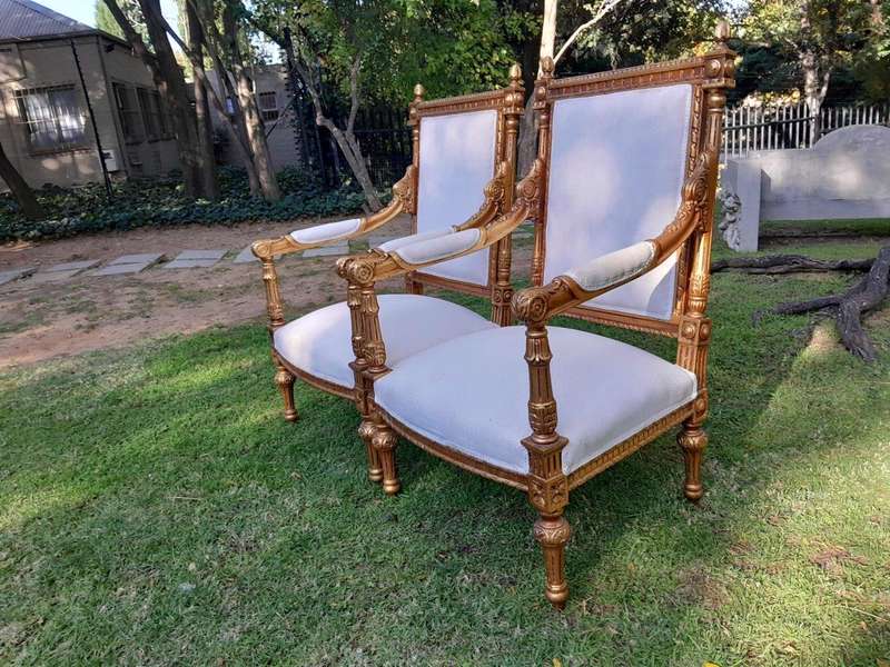 A Pair of French Style Ornately Carved Giltwood Arm Chairs