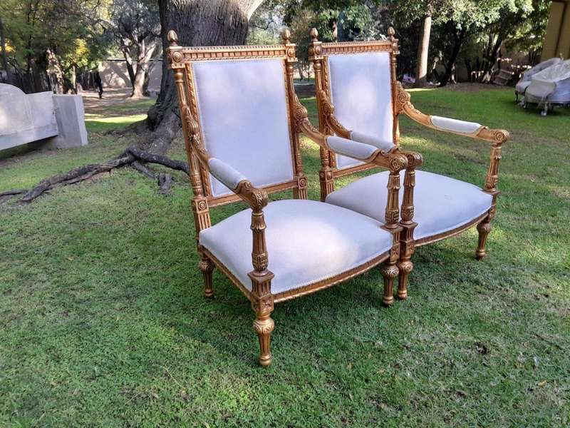 A Pair of French Style Ornately Carved Giltwood Arm Chairs