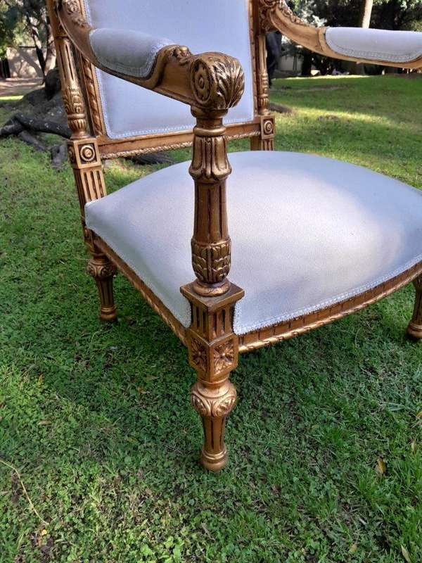A Pair of French Style Ornately Carved Giltwood Arm Chairs