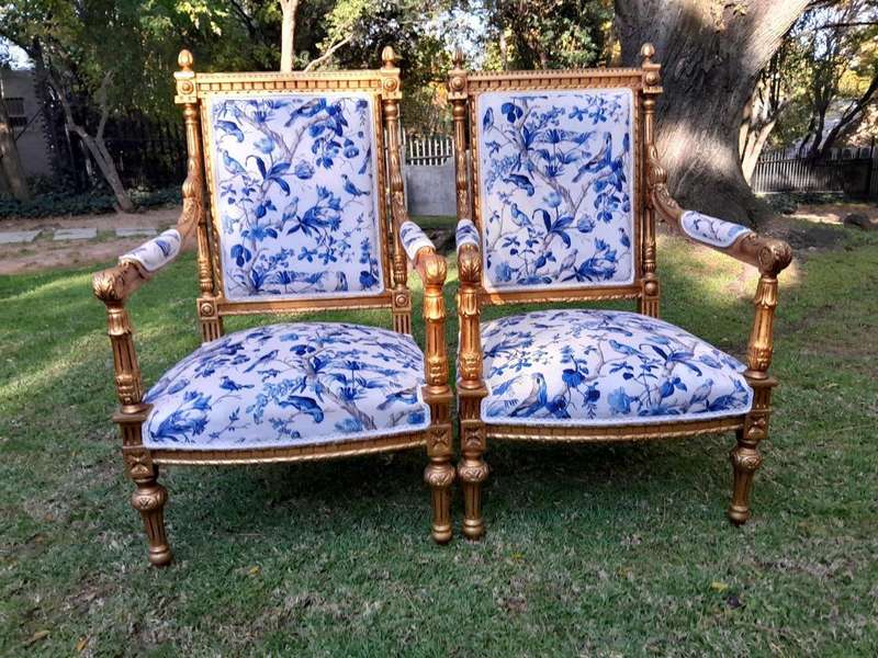 A Pair of French Style Ornately Carved Giltwood Arm Chairs