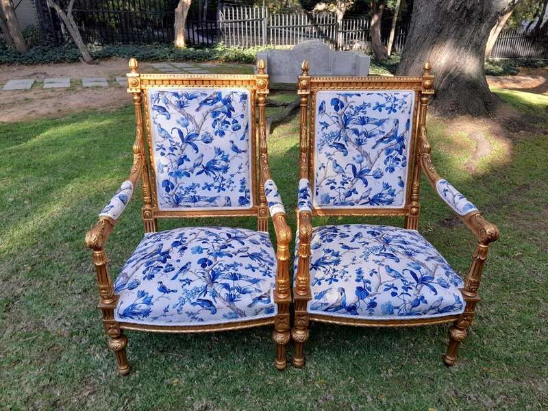 A Pair of French Style Ornately Carved Giltwood Arm Chairs
