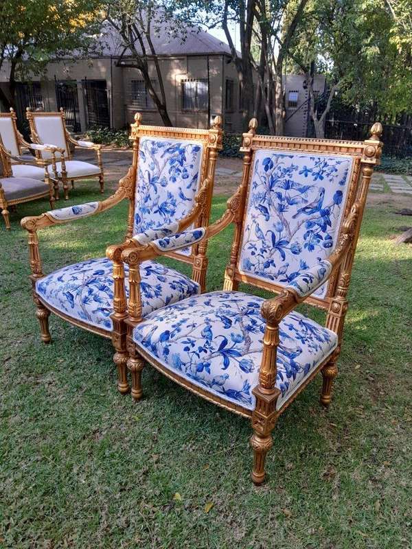 A Pair of French Style Ornately Carved Giltwood Arm Chairs