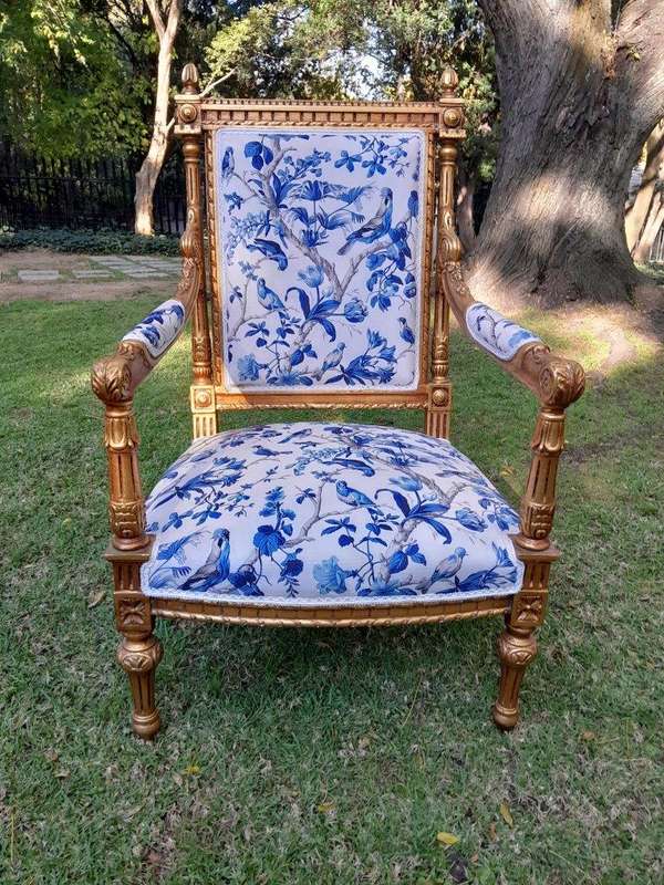 A Pair of French Style Ornately Carved Giltwood Arm Chairs