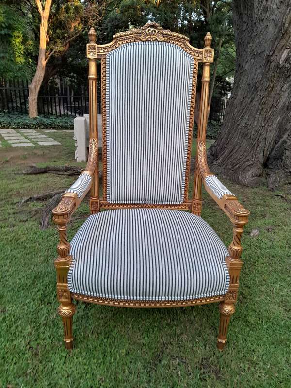 A Pair of French Rococo Style Ornately Carved Giltwood Arm Chairs Upholstered in a Contemporary T...