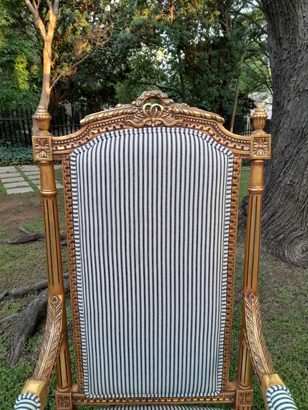 A Pair of French Rococo Style Ornately Carved Giltwood Arm Chairs Upholstered in a Contemporary T...