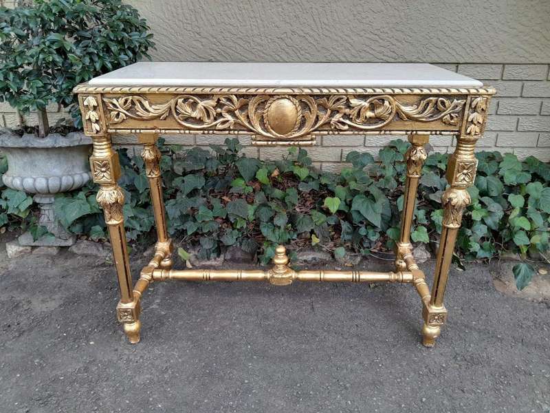A 20th Century Ornately Carved and Hand-Gilded Console Table with Cream Marble Top