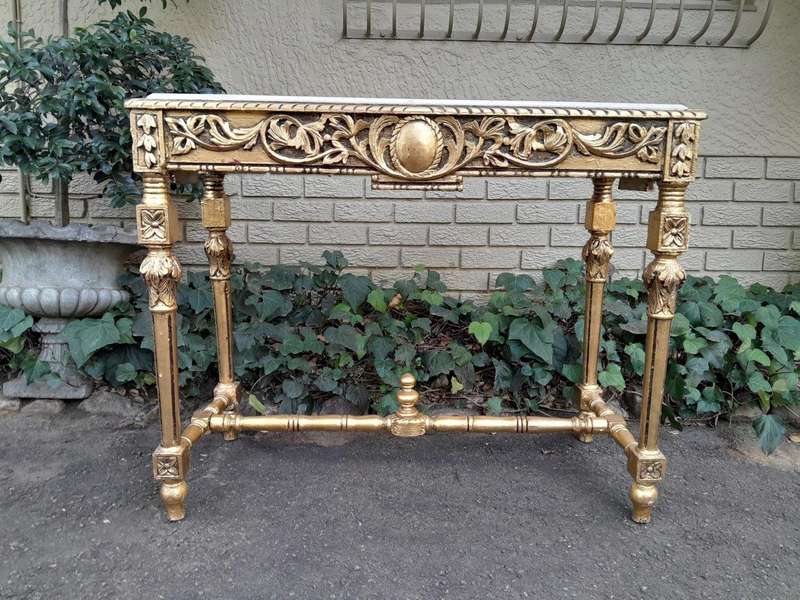 A 20th Century Ornately Carved and Hand-Gilded Console Table with Cream Marble Top