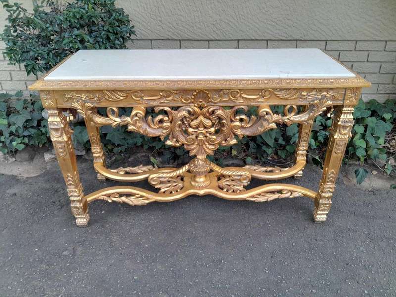 A 20th Century Ornately Carved and Hand-Gilded Console Table with Cream Marble Top