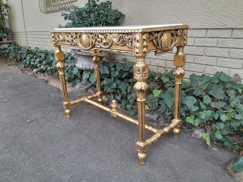 A 20th Century Ornately Carved and Hand-Gilded Console Table with Cream Marble Top