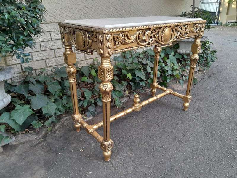 A 20th Century Ornately Carved and Hand-Gilded Console Table with Cream Marble Top
