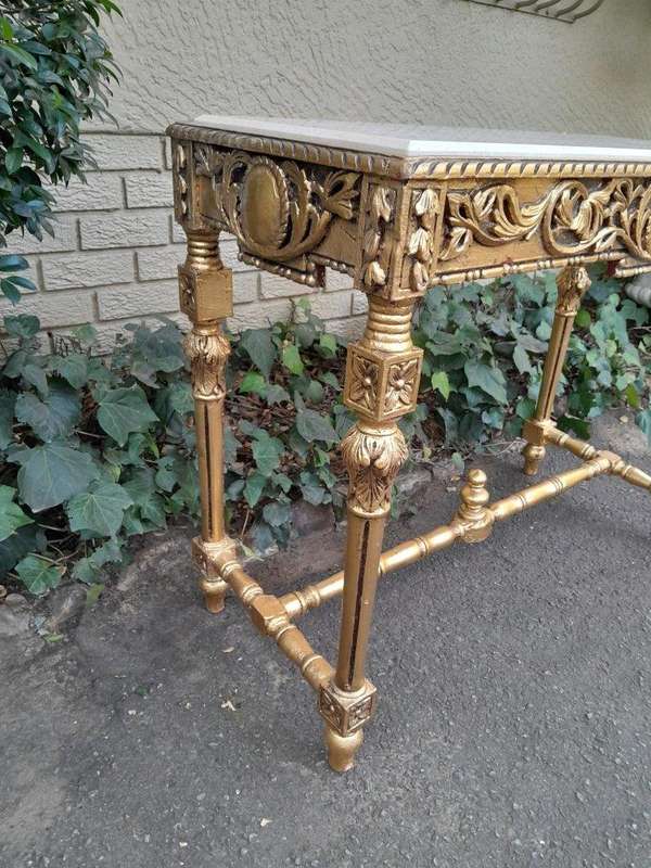 A 20th Century Ornately Carved and Hand-Gilded Console Table with Cream Marble Top