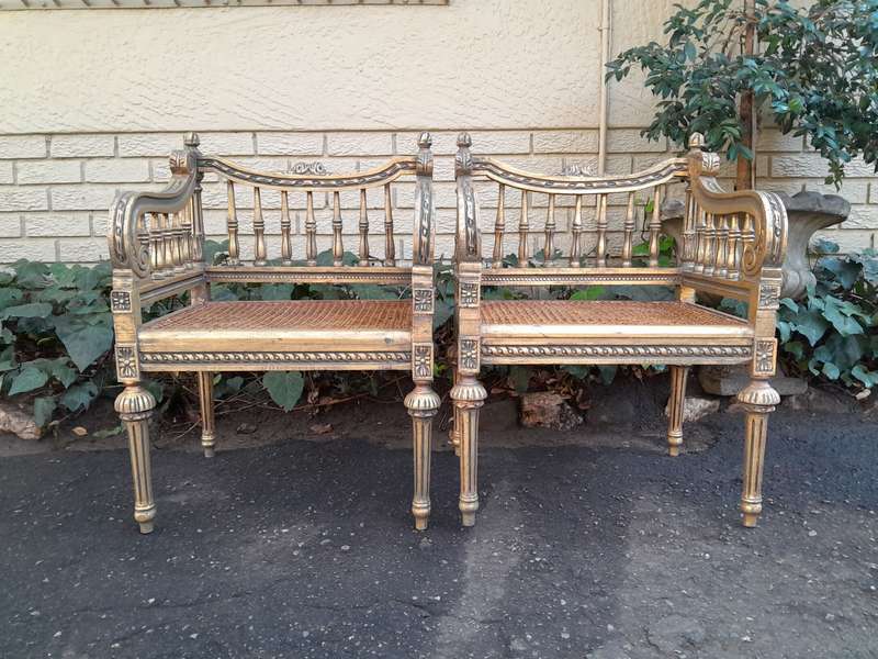 A 20th Century French Style Pair of Ornately Carved and Rattan Arm Chairs