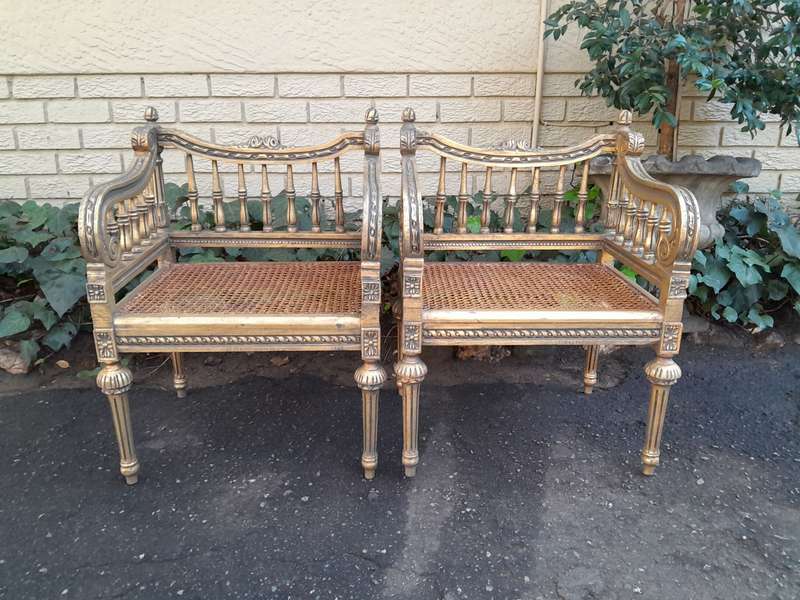 A 20th Century French Style Pair of Ornately Carved and Rattan Arm Chairs