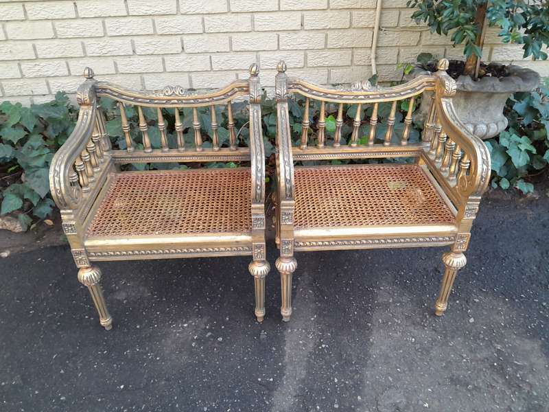 A 20th Century French Style Pair of Ornately Carved and Rattan Arm Chairs