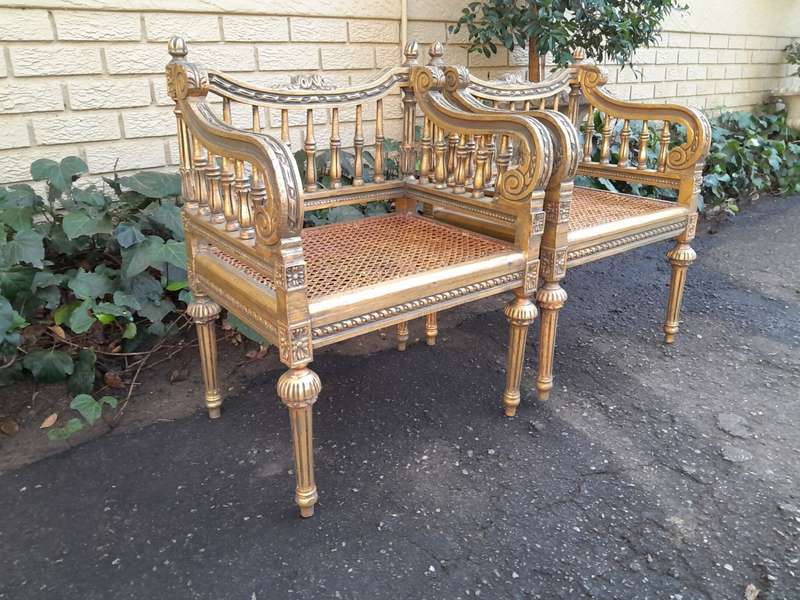 A 20th Century French Style Pair of Ornately Carved and Rattan Arm Chairs