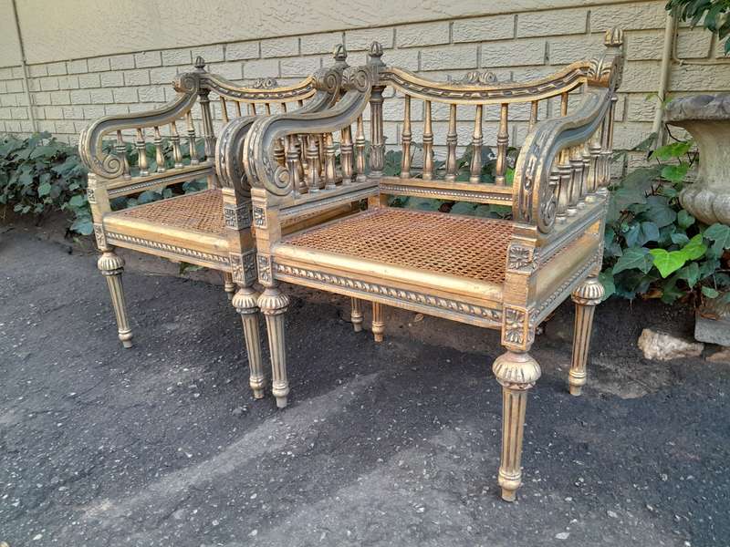 A 20th Century French Style Pair of Ornately Carved and Rattan Arm Chairs