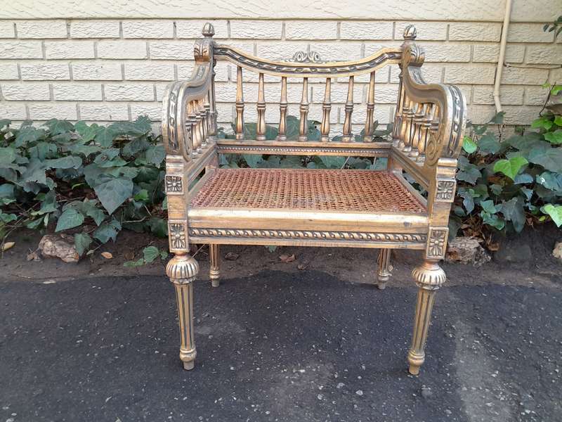 A 20th Century French Style Pair of Ornately Carved and Rattan Arm Chairs