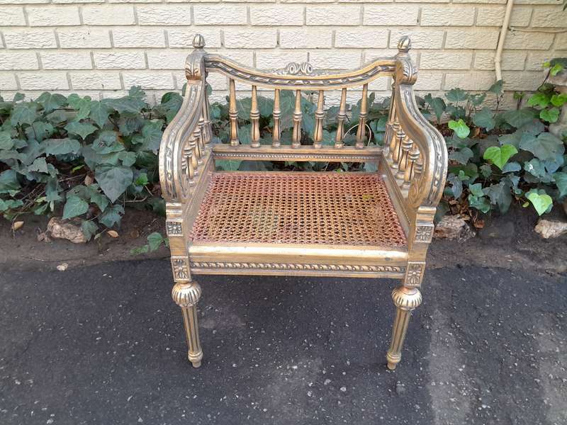 A 20th Century French Style Pair of Ornately Carved and Rattan Arm Chairs