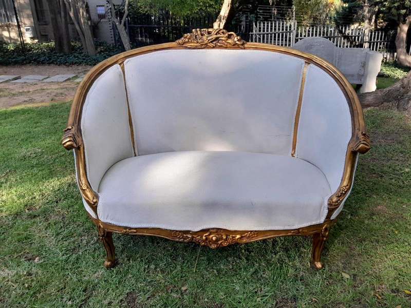 A French Style Ornately Carved and Gilded Bergere Chair