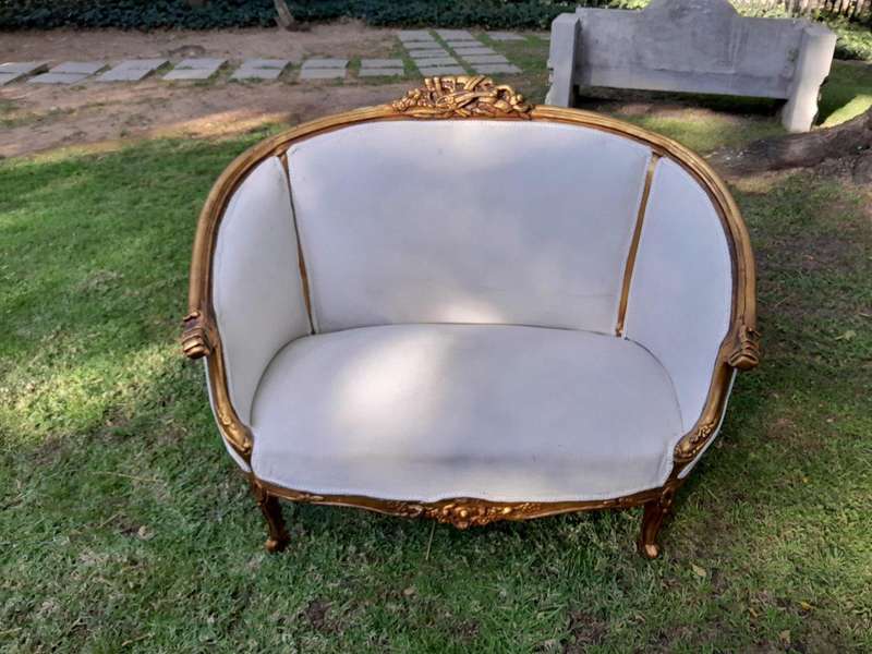 A French Style Ornately Carved and Gilded Bergere Chair