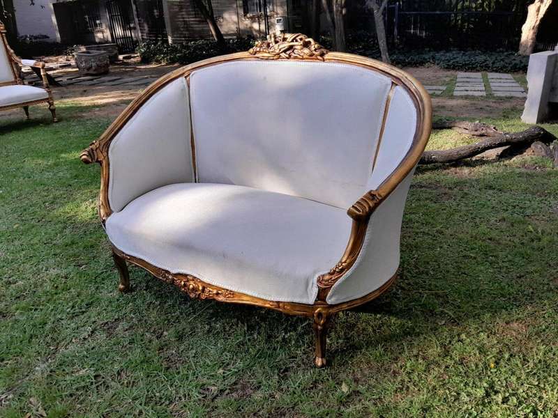 A French Style Ornately Carved and Gilded Bergere Chair