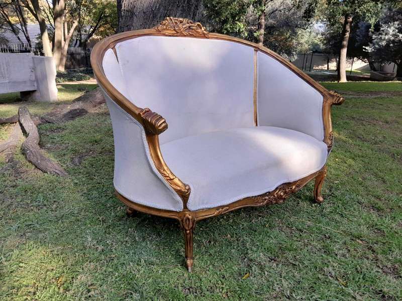A French Style Ornately Carved and Gilded Bergere Chair