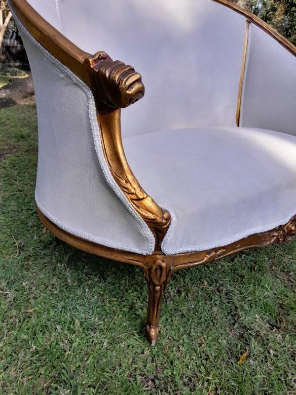 A French Style Ornately Carved and Gilded Bergere Chair