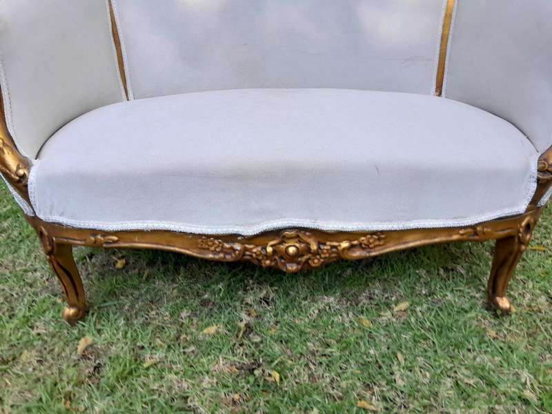 A French Style Ornately Carved and Gilded Bergere Chair