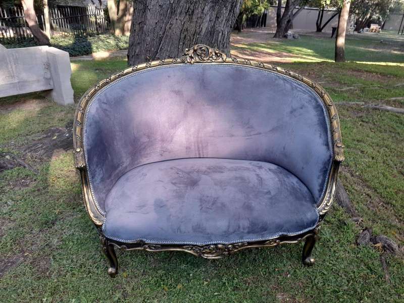 A French Style Ornately Carved and Gilded Bergere Chair