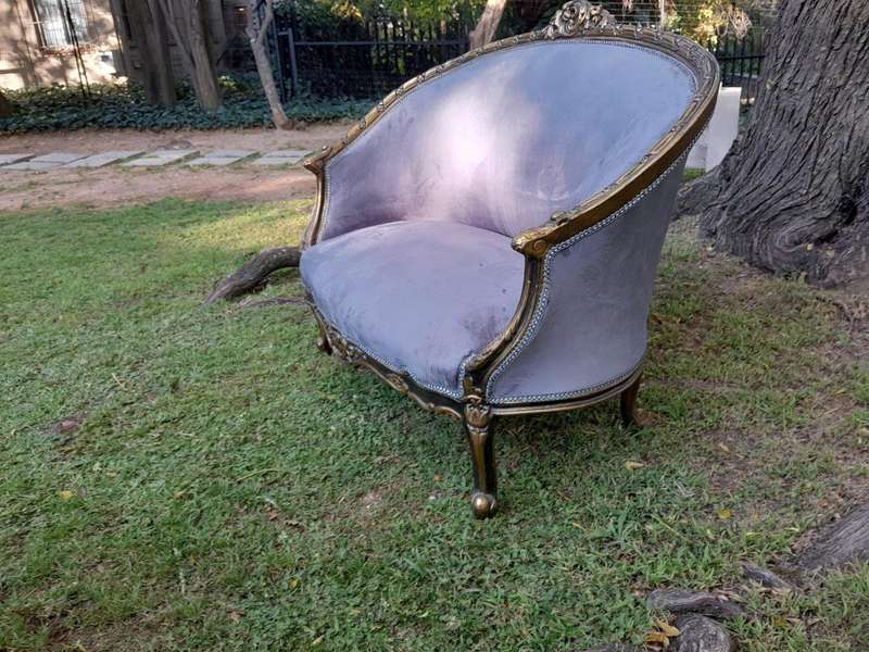 A French Style Ornately Carved and Gilded Bergere Chair