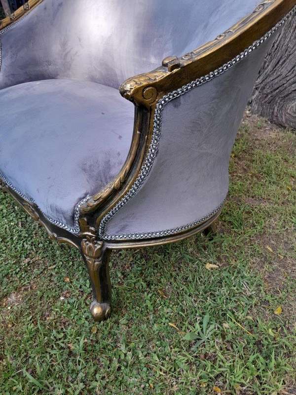 A French Style Ornately Carved and Gilded Bergere Chair