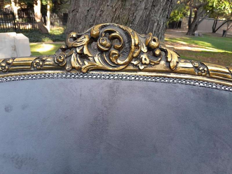 A French Style Ornately Carved and Gilded Bergere Chair