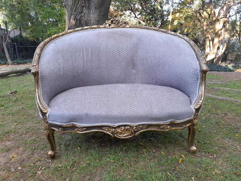 A French Style Ornately Carved and Gilded Bergere Chair