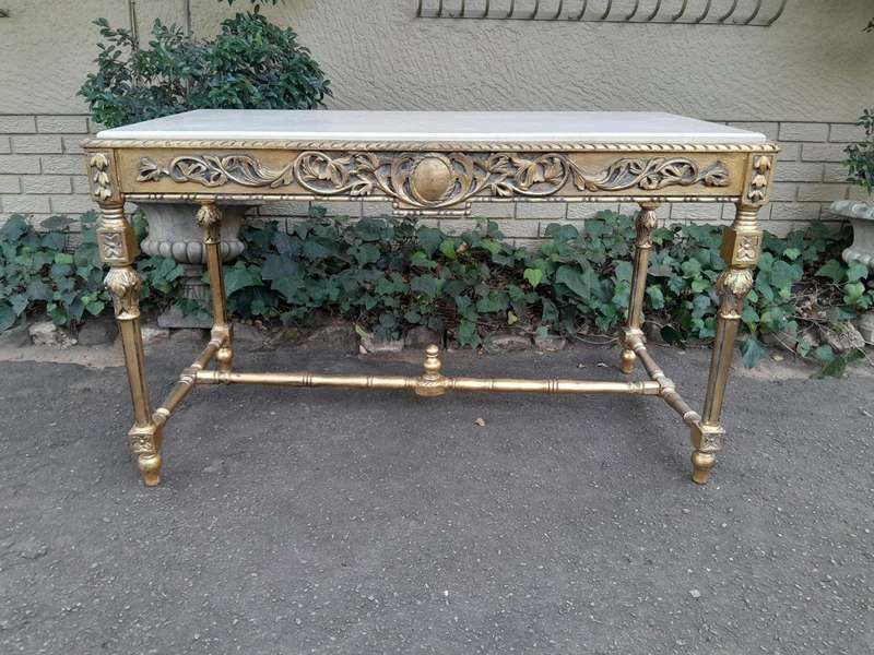 A 20th Century Ornately Carved and Hand-Gilded Console Table with Cream Marble Top