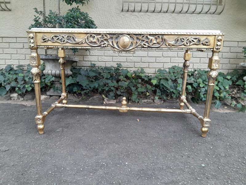 A 20th Century Ornately Carved and Hand-Gilded Console Table with Cream Marble Top