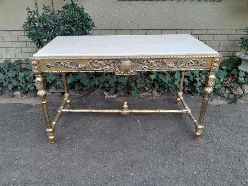 A 20th Century Ornately Carved and Hand-Gilded Console Table with Cream Marble Top
