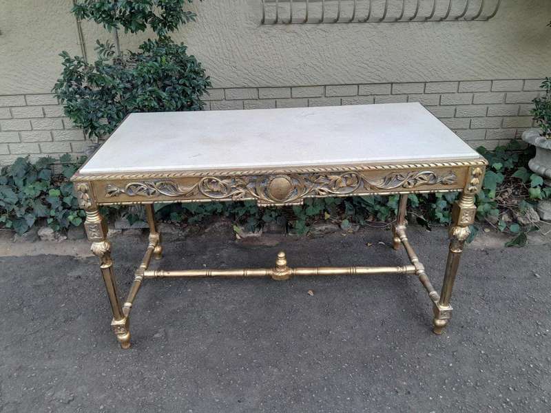 A 20th Century Ornately Carved and Hand-Gilded Console Table with Cream Marble Top