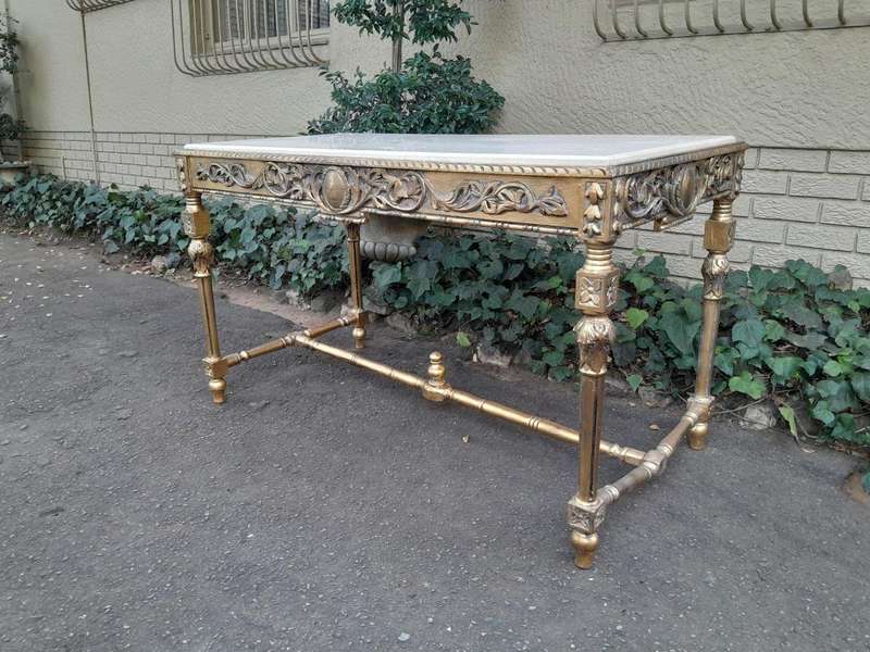 A 20th Century Ornately Carved and Hand-Gilded Console Table with Cream Marble Top