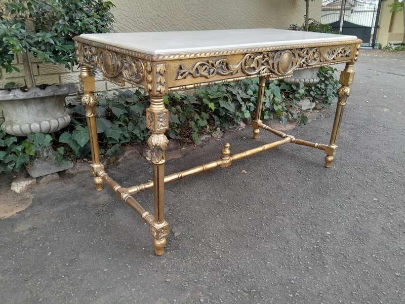 A 20th Century Ornately Carved and Hand-Gilded Console Table with Cream Marble Top