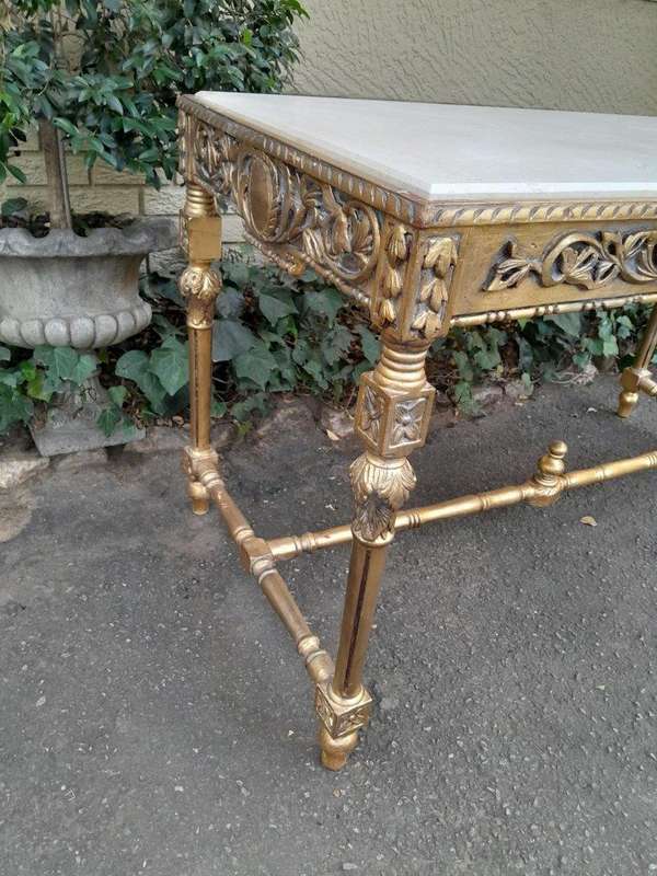 A 20th Century Ornately Carved and Hand-Gilded Console Table with Cream Marble Top