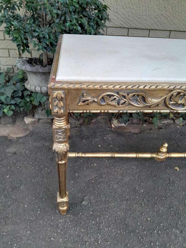 A 20th Century Ornately Carved and Hand-Gilded Console Table with Cream Marble Top