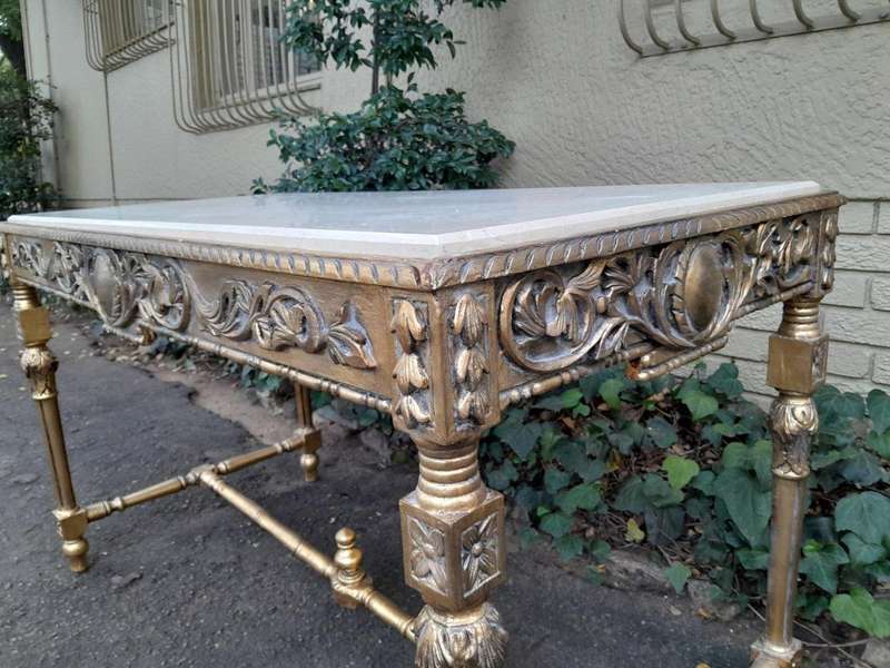 A 20th Century Ornately Carved and Hand-Gilded Console Table with Cream Marble Top