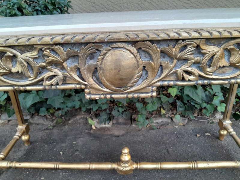 A 20th Century Ornately Carved and Hand-Gilded Console Table with Cream Marble Top