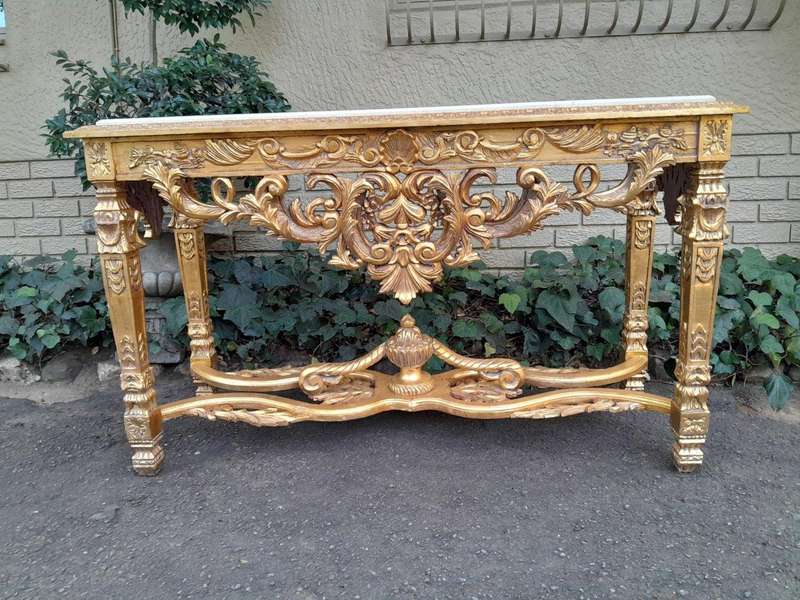 A 20th Century Ornately Carved and Hand-Gilded Console Table with Cream Marble Top