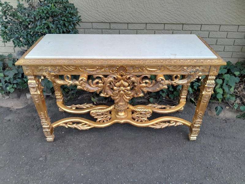 A 20th Century Ornately Carved and Hand-Gilded Console Table with Cream Marble Top