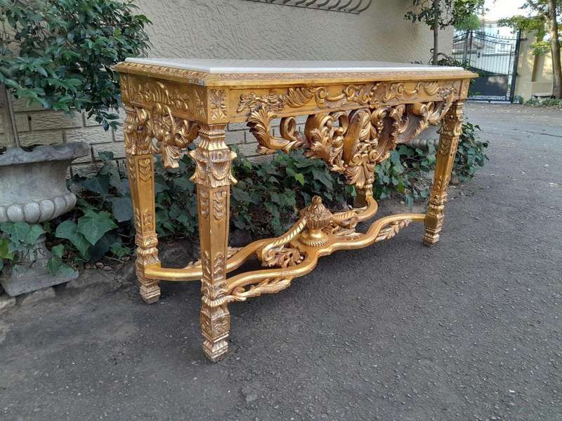 A 20th Century Ornately Carved and Hand-Gilded Console Table with Cream Marble Top
