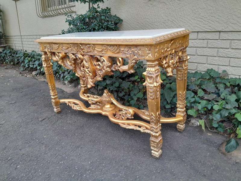A 20th Century Ornately Carved and Hand-Gilded Console Table with Cream Marble Top