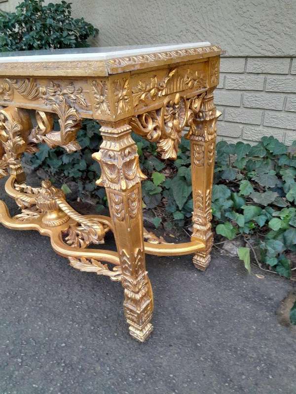 A 20th Century Ornately Carved and Hand-Gilded Console Table with Cream Marble Top